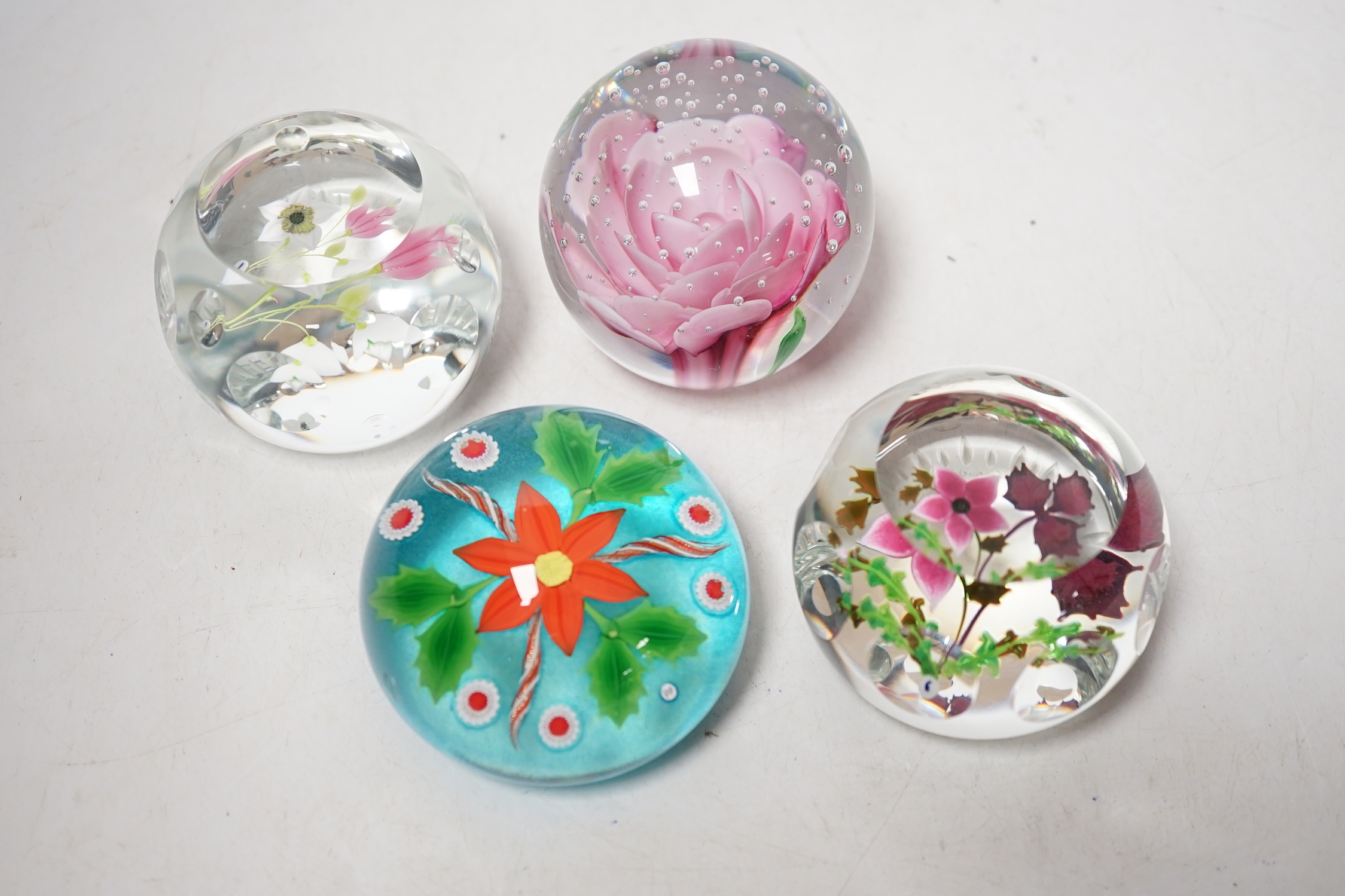 Four lampwork glass flower paperweights, Phoenix, 10/50, Caithness 199/250 and 194/250 and another, 7.5cm in diameter (4)